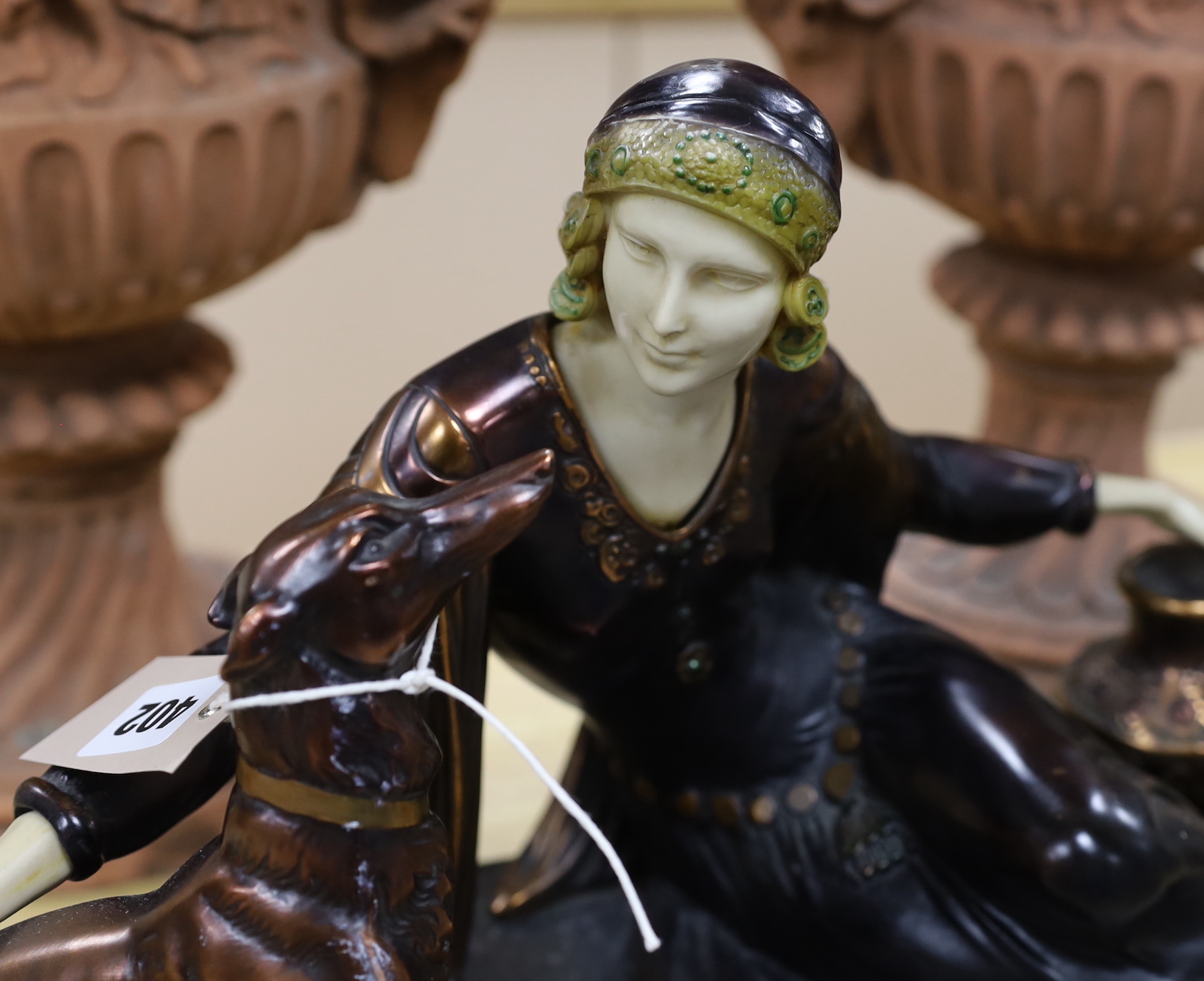 An Art Deco style resin and marble figure group, length of base, 57cm